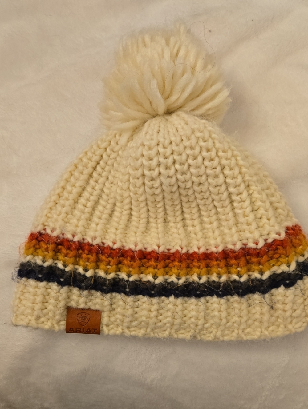 Ariat Cream Knit Pom Pom Beanie with Red, Yellow & Blue Stripes